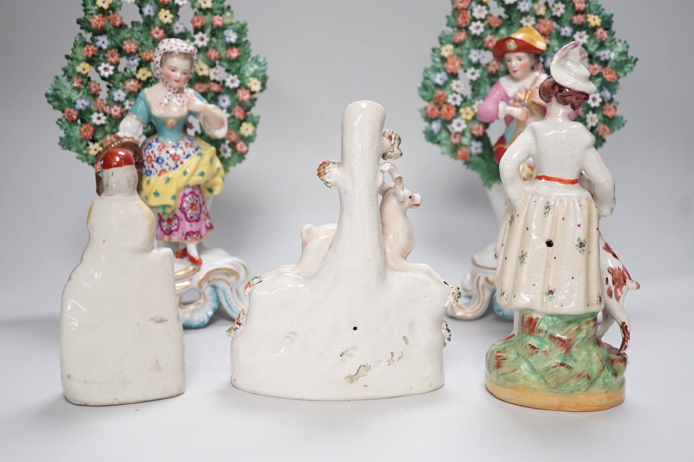 A pair of Derby style bocage figures and three other figures, tallest 26cms high